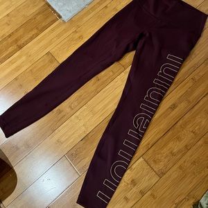 Lululemon maroon leggings with gold print down leg